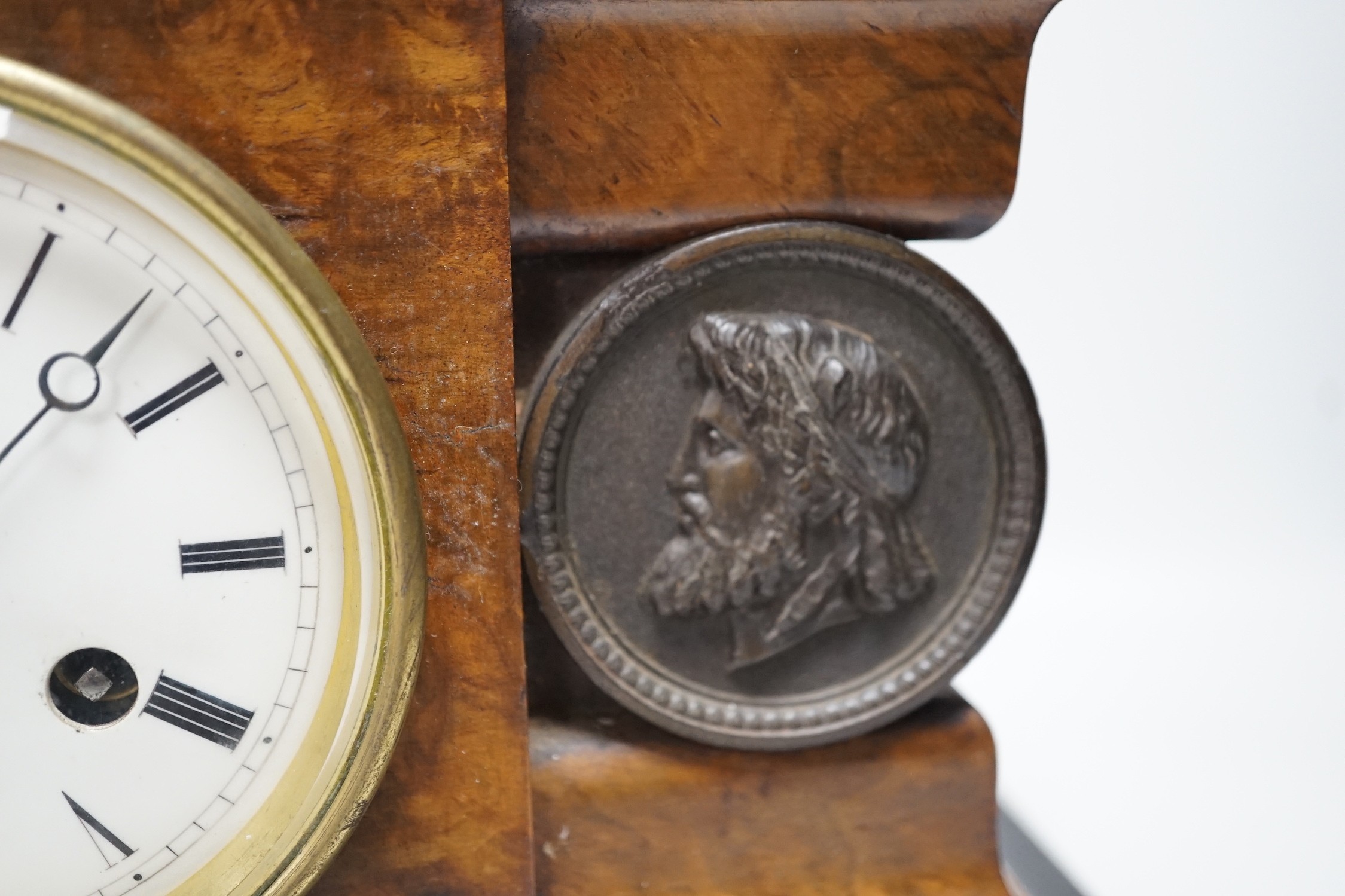 A Victorian walnut and ebonised bracket clock with two classical cartouches, 33cms wide x 23cms high not including bracket